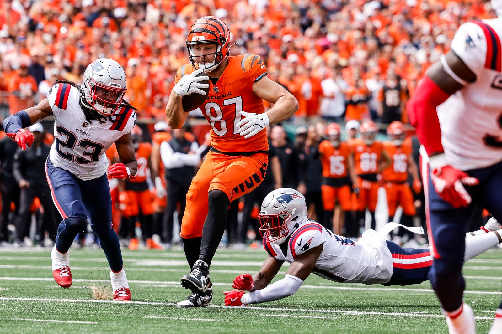 Bengals tight end Tanner Hudson runs after a catch before fumbling the ball for a turnover during their 16-10 loss to New England Patriots Sunday, Sept. 8, 2024 at Paycor Stadium in Cincinnati. The call was reviewed and called an incomplete pass. NICK GRAHAM/STAFF