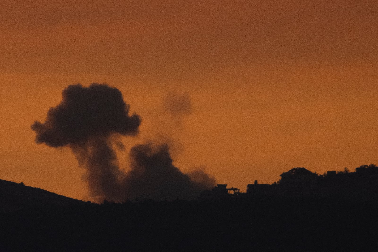 Smoke rises following an explosion in southern Lebanon as seen from northern Israel, Sunday, Oct. 20, 2024. (AP Photo/Leo Correa)