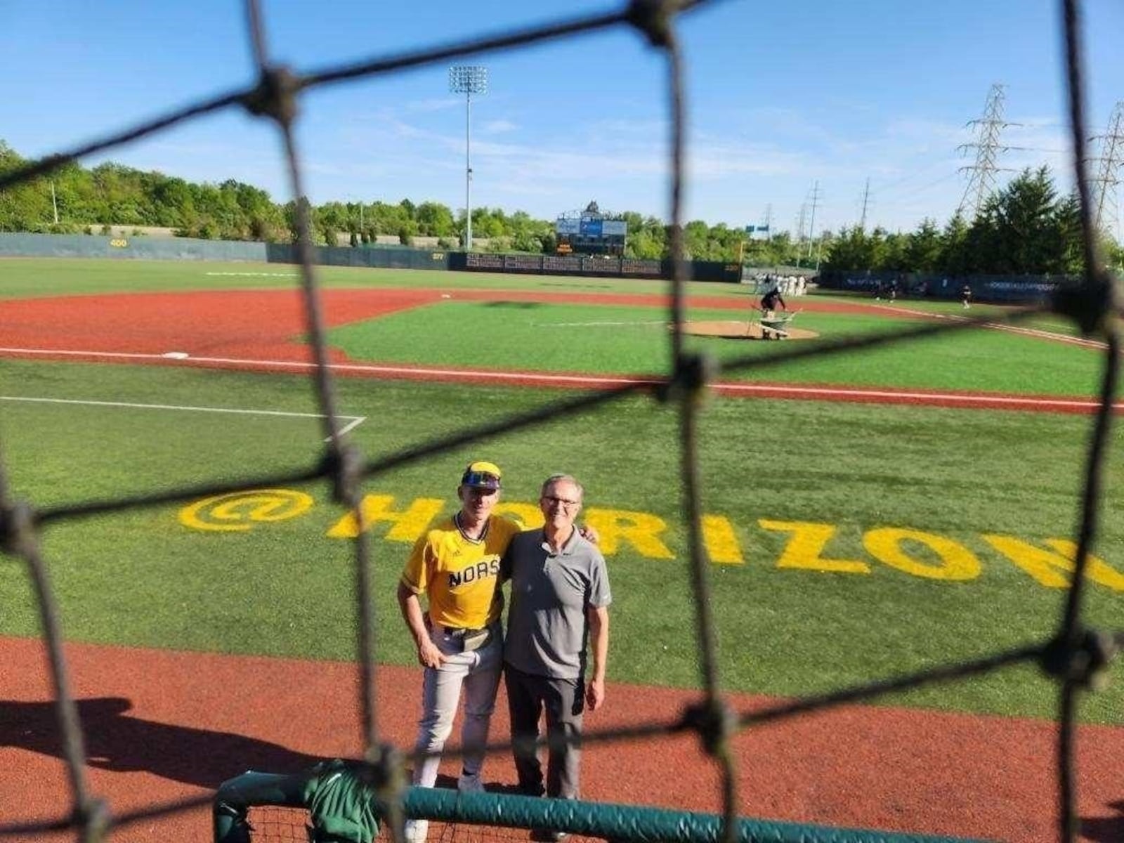 Northern Kentucky baseball player Colton Kucera (left) and Dr. Greg Notestine on the field at Nischwitz Stadium in May during the Horizon League Tournament. CONTRIBUTED