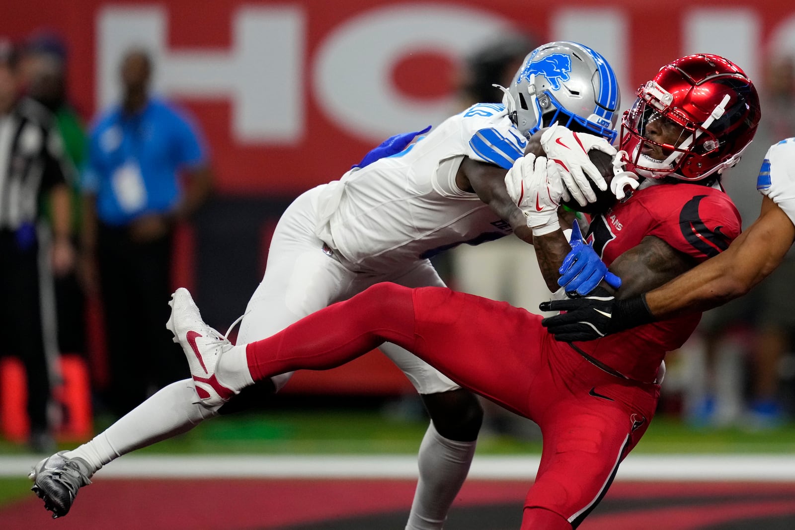 Houston Texans wide receiver John Metchie III catches a 15-yard touchdown pass in front of Detroit Lions cornerback Terrion Arnold, left, during the first half of an NFL football game, Sunday, Nov. 10, 2024, in Houston. (AP Photo/David J. Phillip)