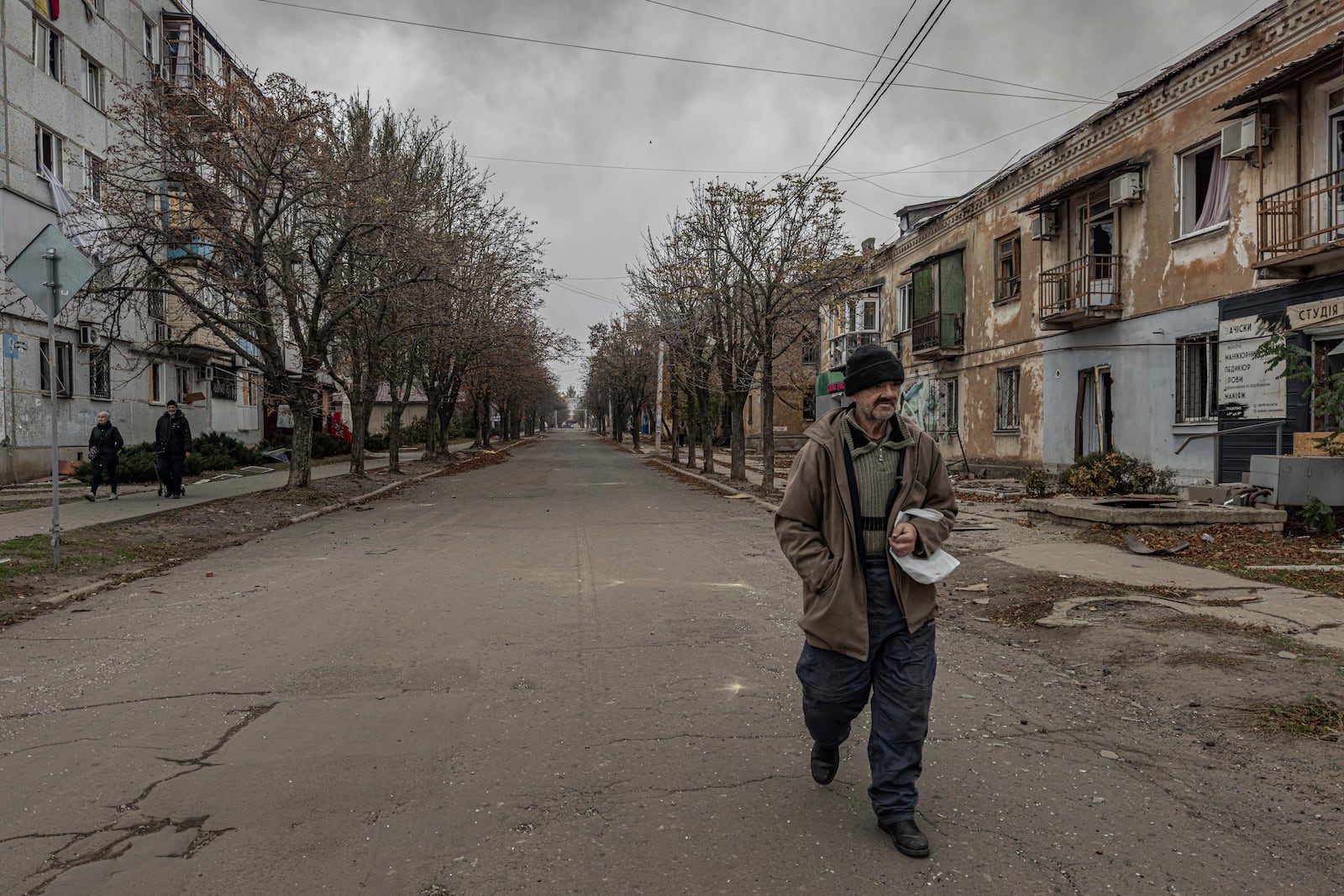 A man walks on a street as he looks for food in Kurakhove, Donetsk region, Ukraine, on Nov. 7, 2024. (AP Photo/Anton Shtuka)