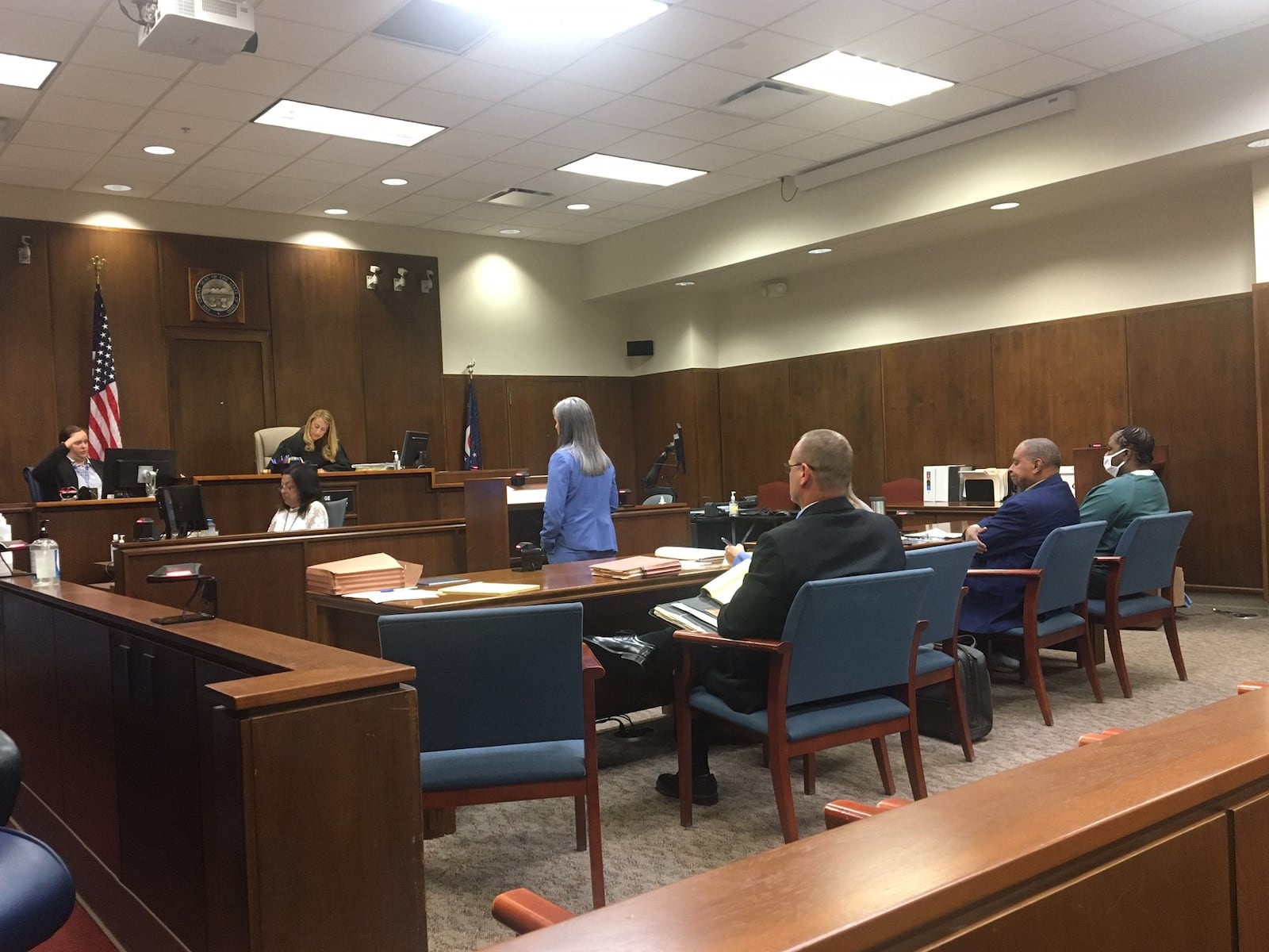 Wanisha Smith, far right, listens as Dayton Police Detective Sarah Moody recounts finding a baby dead inside an apartment alone.