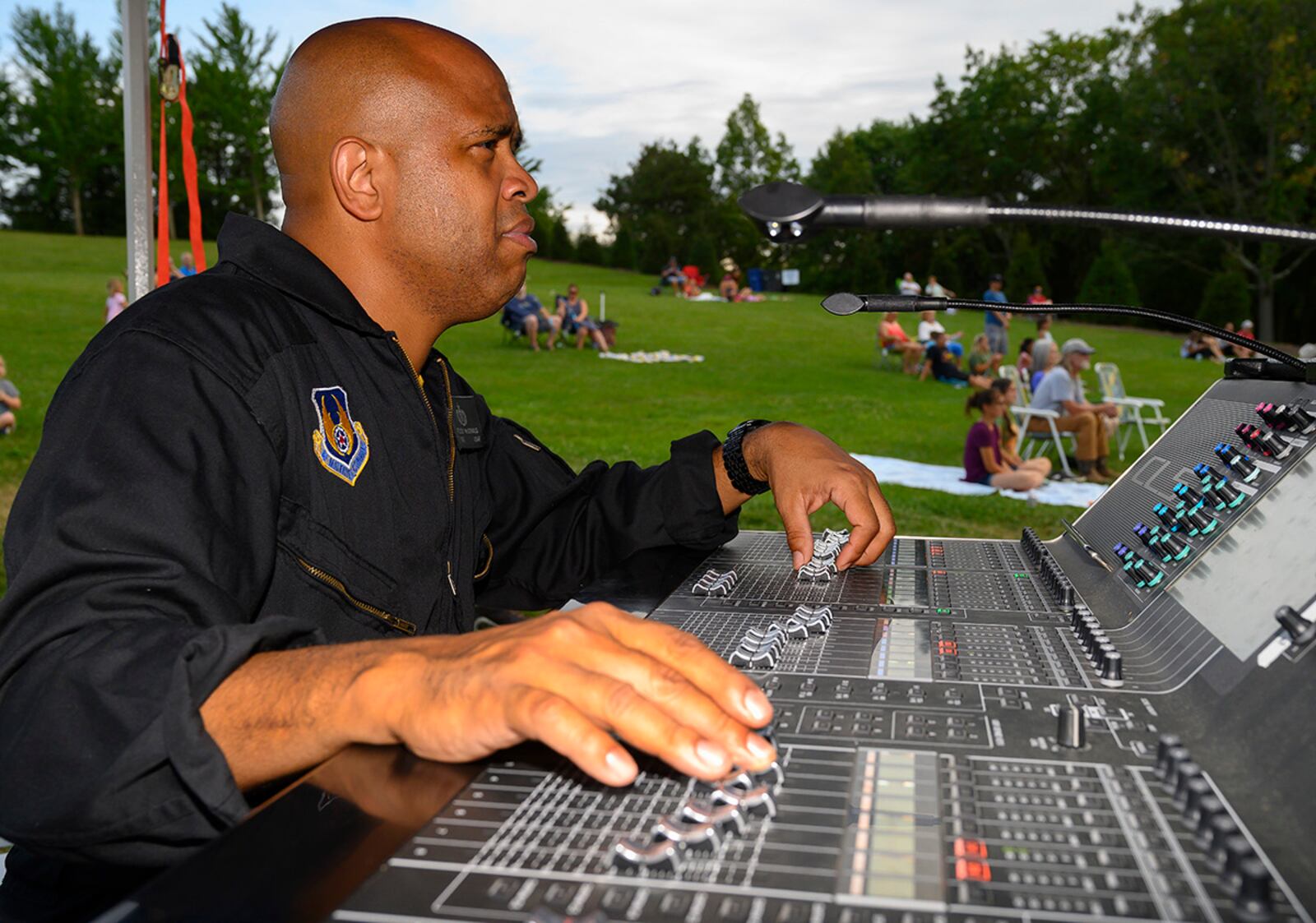 Tech. Sgt. Kelcey McDonald, Flight One audio engineer, works the soundboard during a performance by the Air Force Band of Flight’s rock ensemble Aug. 13 at Centerville Community Amphitheater in Stubbs Park. McDonald is just as integral to the Air Force rock band as any of the musicians on stage. U.S. AIR FORCE PHOTO/R.J. ORIEZ