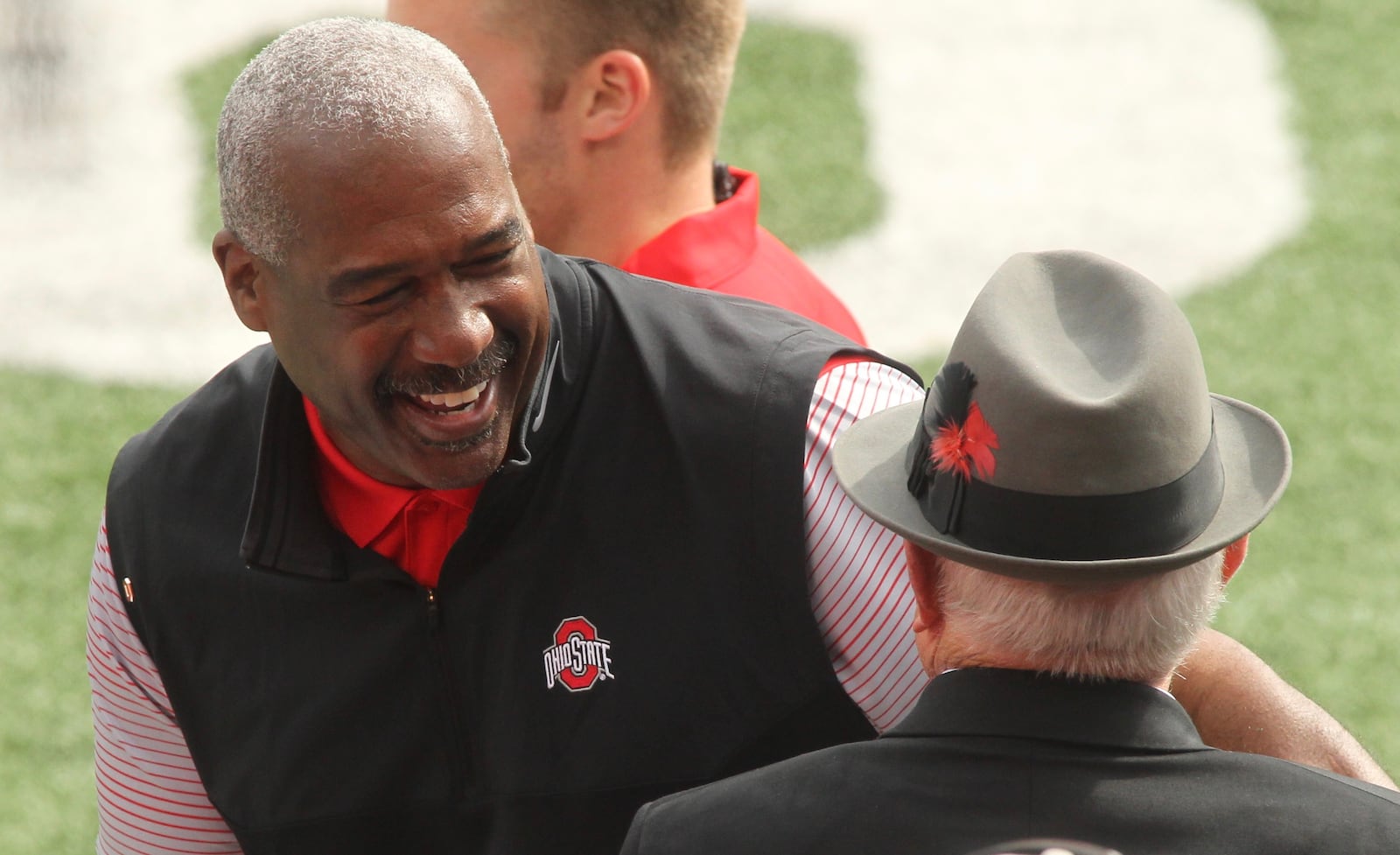 Ohio State Athletic Director Gene Smith smiles as he talks to former coach Earle Bruce before a game against Rutgers on Saturday, Oct. 1, 2016, at Ohio Stadium in Columbus. David Jablonski/Staff