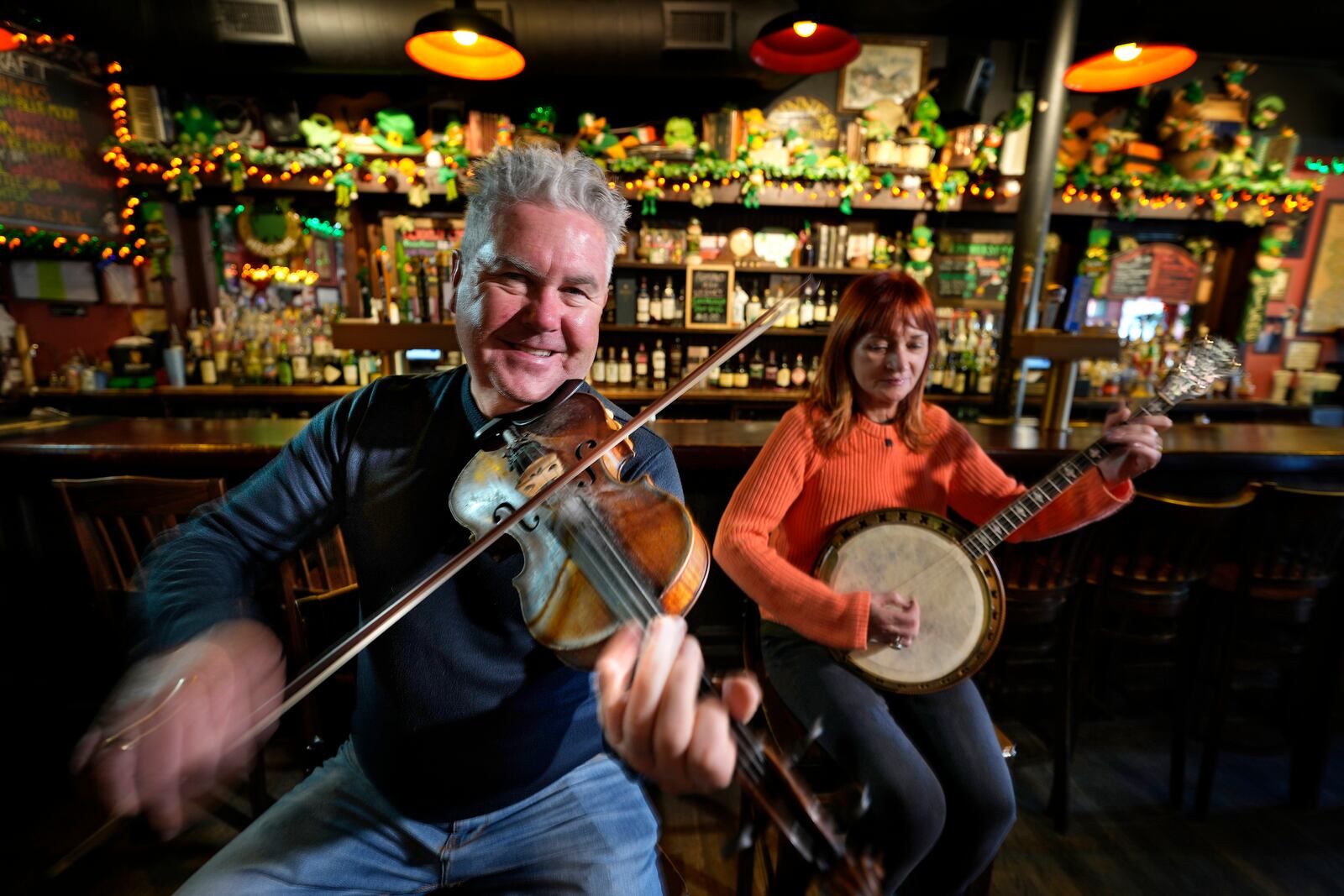 Tommy McCarthy and his wife Louise Costello, owners of the Burren Pub, play an Irish tune, Wednesday, March 12, 2025, in Somerville, Mass. (AP Photo/Robert F. Bukaty)