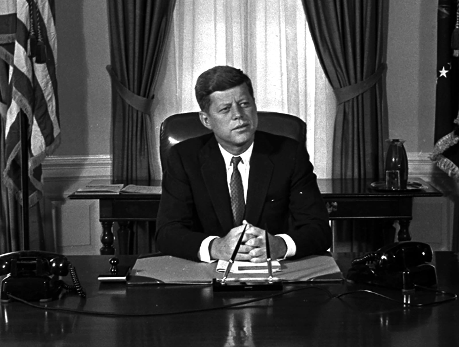 FILE - Newly-elected President Kennedy posed for first pictures at his White House desk, Jan. 21, 1961, before plunging into a busy round of conferences. (AP Photo/Bill Achatz, File)