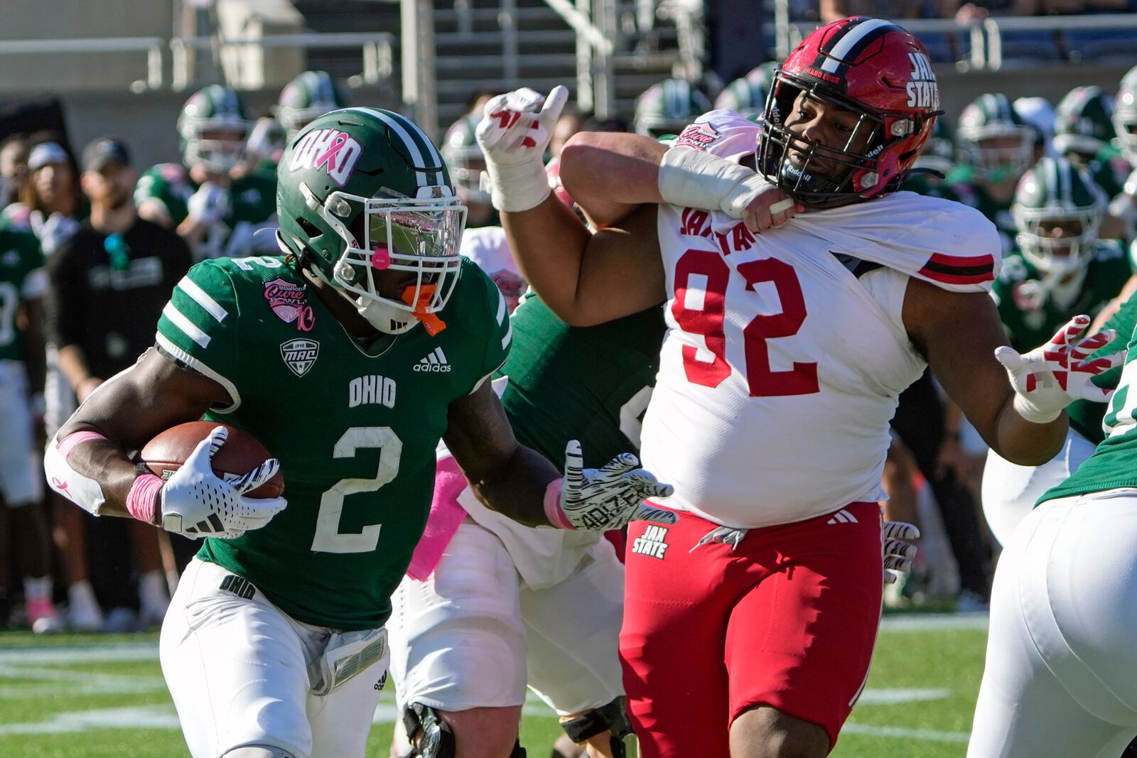 Ohio running back Anthony Tyus III (2) runs past Jacksonville State defensive lineman Talan Carter (92) for yardage during the second half of the Cure Bowl NCAA college football game, Friday, Dec. 20, 2024, in Orlando, Fla. (AP Photo/John Raoux)