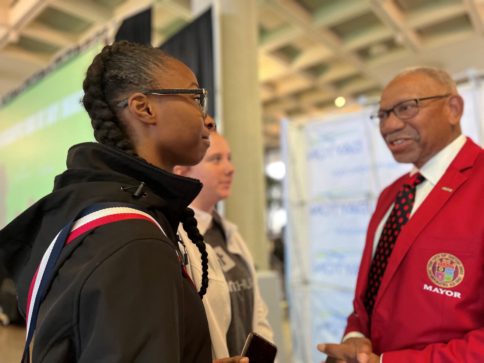 A Dayton teen youth summit was held Wednesday, Oct. 26, 2022, at Sinclair Community College. It was organized by Mayor Jeffrey Mims Jr., seen here talking to Escalajah Draper and Gwenyth Planck, who are both 16 and attend Thurgood Marshall STEM High School. CORNELIUS FROLIK / STAFF