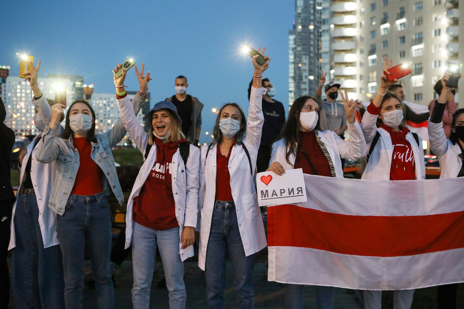 Belarusian medical workers gesture during a rally in support of Maria Kolesnikova, and other members of the Coordination Council created by the opposition to facilitate talks with Lukashenko on a transition of power, was detained Monday in the capital of Minsk with two other council members, in Minsk, Belarus, Wednesday, Sept. 9, 2020. The leading opposition candidate in Belarus' disputed presidential election said Wednesday that the political tension in her country should be solved internally, by the Belarusian people, but she did not exclude the need for future international mediation. (AP Photo)