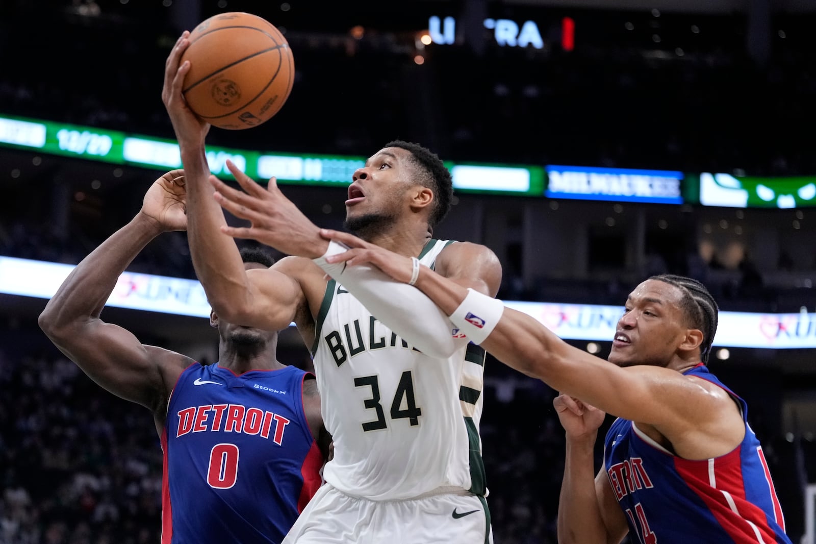 Detroit Pistons' Wendell Moore Jr. fouls Milwaukee Bucks' Giannis Antetokounmpo during the second half of an NBA basketball game Wednesday, Nov. 13, 2024, in Milwaukee. (AP Photo/Morry Gash)