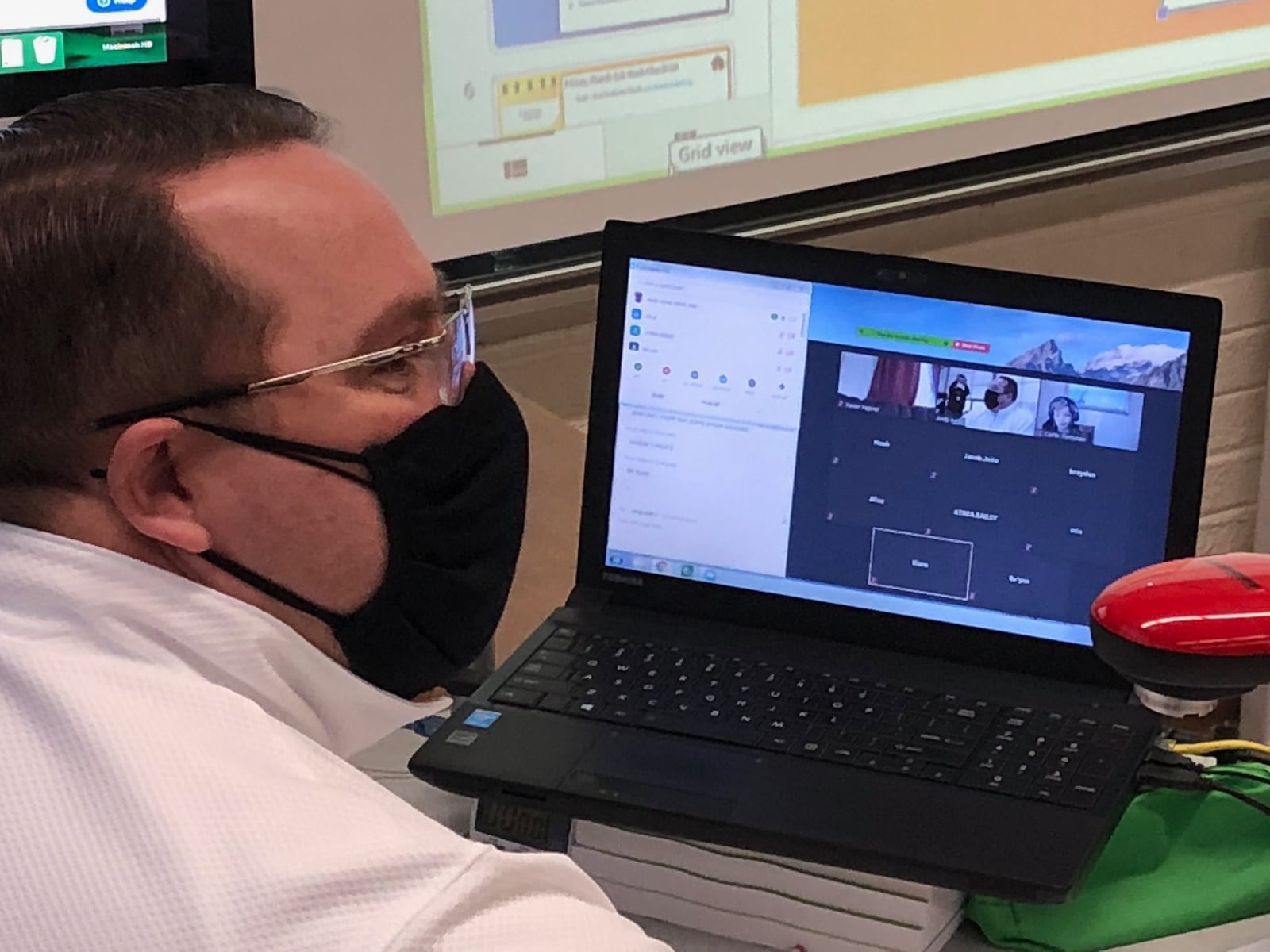 At Orchard Park Elementary School in Kettering, math teacher Andy Ayres simultaneously teaches some students who are watching from home, while working with the students who are sitting in his classroom March 2, 2021.