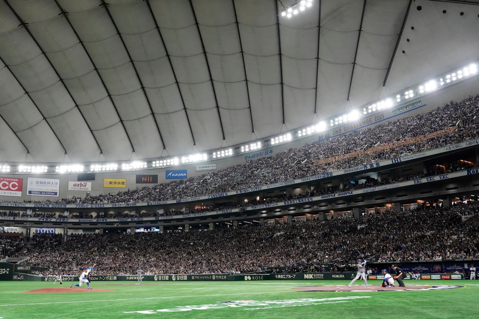 Chicago Cubs starting pitcher Shota Imanaga, left, throws to Los Angeles Dodgers' Shohei Ohtani, right, in the first inning of an MLB Japan Series baseball game in the Tokyo Dome in Tokyo, Japan, Tuesday, March 18, 2025. (AP Photo/Eugene Hoshiko)