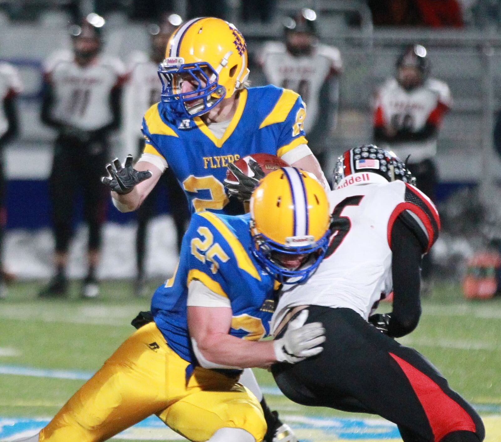 Dylan Heitkamp of Marion Local (with ball) gets a block from teammate Drandon Fleck. Marion Local defeated Fort Loramie 24-21 in OT in a Division VII, Region 28 high school football regional semifinal at St. Marys Memorial on Saturday, Nov. 16, 2019. MARC PENDLETON / STAFF