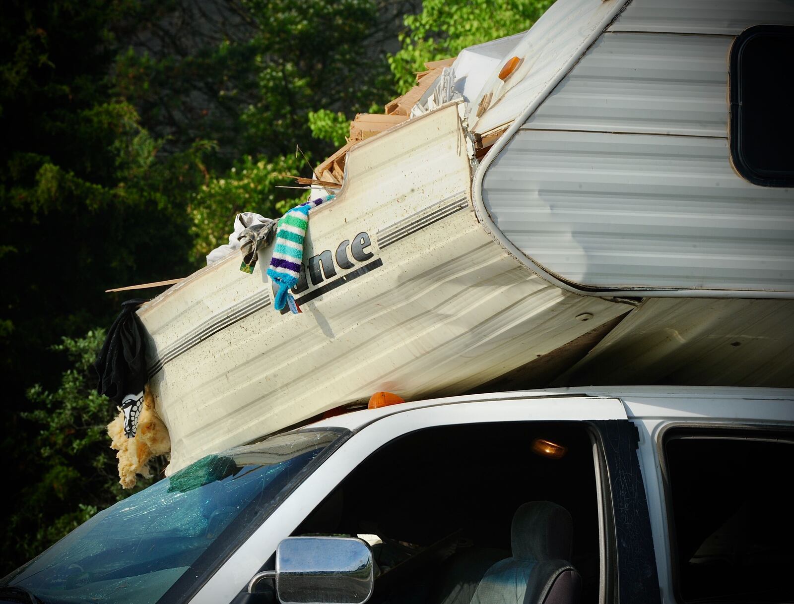 A pickup truck hauling a camper and a semi truck were involved in a crash on I-70 east near Brookville Thursday, May 27, 2021. It was one of two crashes that closed the highway Thursday morning. MARSHALL GORBY / STAFF