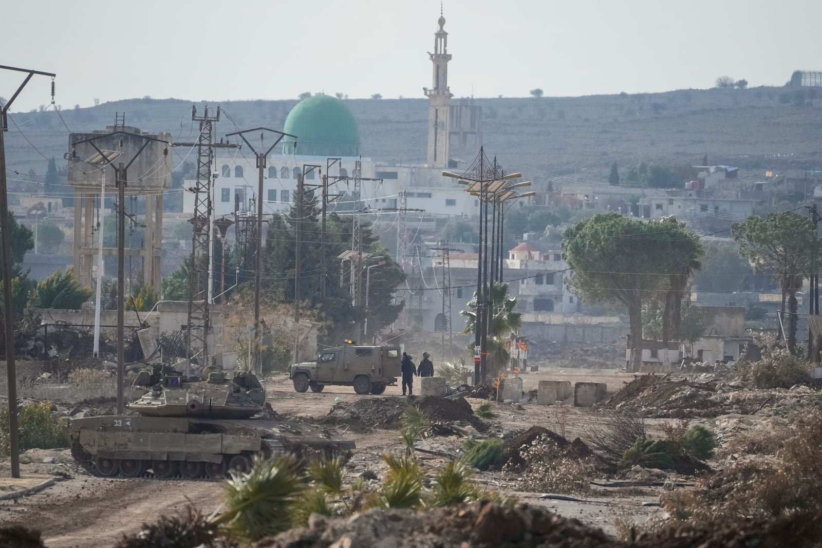 FILE - Israeli army armored vehicles block a road leading to the town of Quneitra, Syria, Jan. 5, 2025. (AP Photo/Mosa'ab Elshamy, File)