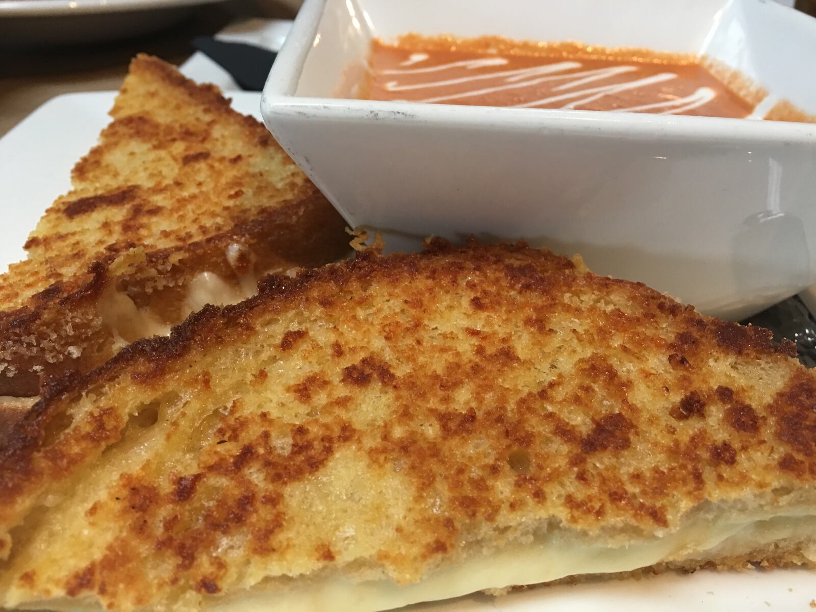 Lunchtime comfort is yours with this sinfully delicious Italian Grilled Cheese served with creamy tomato bisque at Coco's Bistro in Dayton. MICHELLE FONG/STAFF