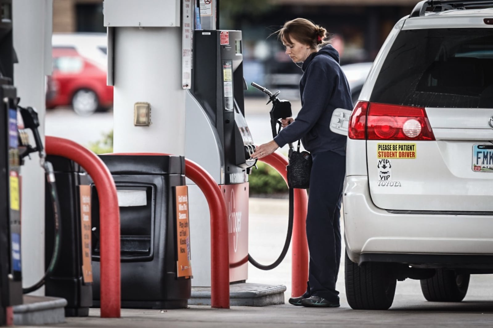 Betsy Benefiel, from Xenia, fills up at the Kroger on West Main Street in Xenia wear the price per gallon is $2.92. Jim Noelker/Staff