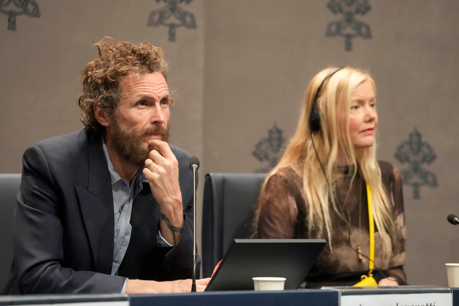 Italian artist Lorenzo Jovanotti Cherubini, left, and Icelandic artist Kristjana S. Williams attend a press conference presenting the exhibition "En Route" organized by the Vatican Apostolic Library exploring world tours of the late 19th century at the Vatican, Friday, Jan. 31, 2025. (AP Photo/Gregorio Borgia)