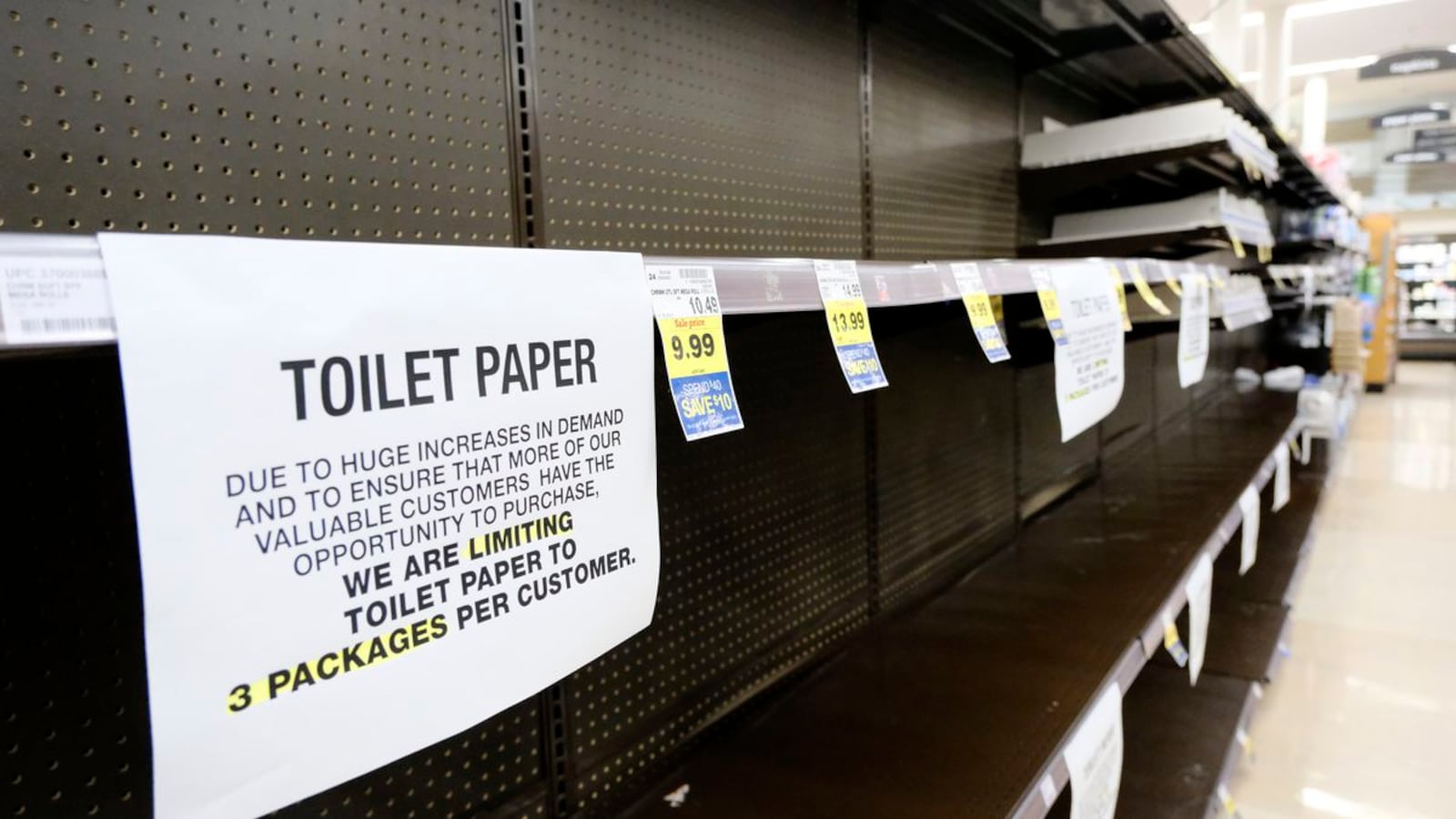 A notice limiting only 3 packages of toilet paper per customer is displayed on picked bare shelves after shoppers cleaned out the stock of paper and cleaning products at a local grocery store in Burbank, Calif. on Saturday, March 14, 2020. Californians wanting to escape the new reality of the coronavirus at the movies, casino or amusement park are running into the six foot rule. State health officials issued new guidance Saturday urging theaters to keep attendance under 250 people and ask strangers to sit six feet apart. (AP Photo/Richard Vogel) (Richard Vogel)