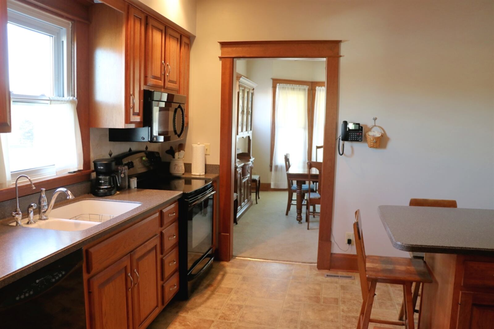 The kitchen has been updated and features Corian counters and lots of hickory cabinetry.