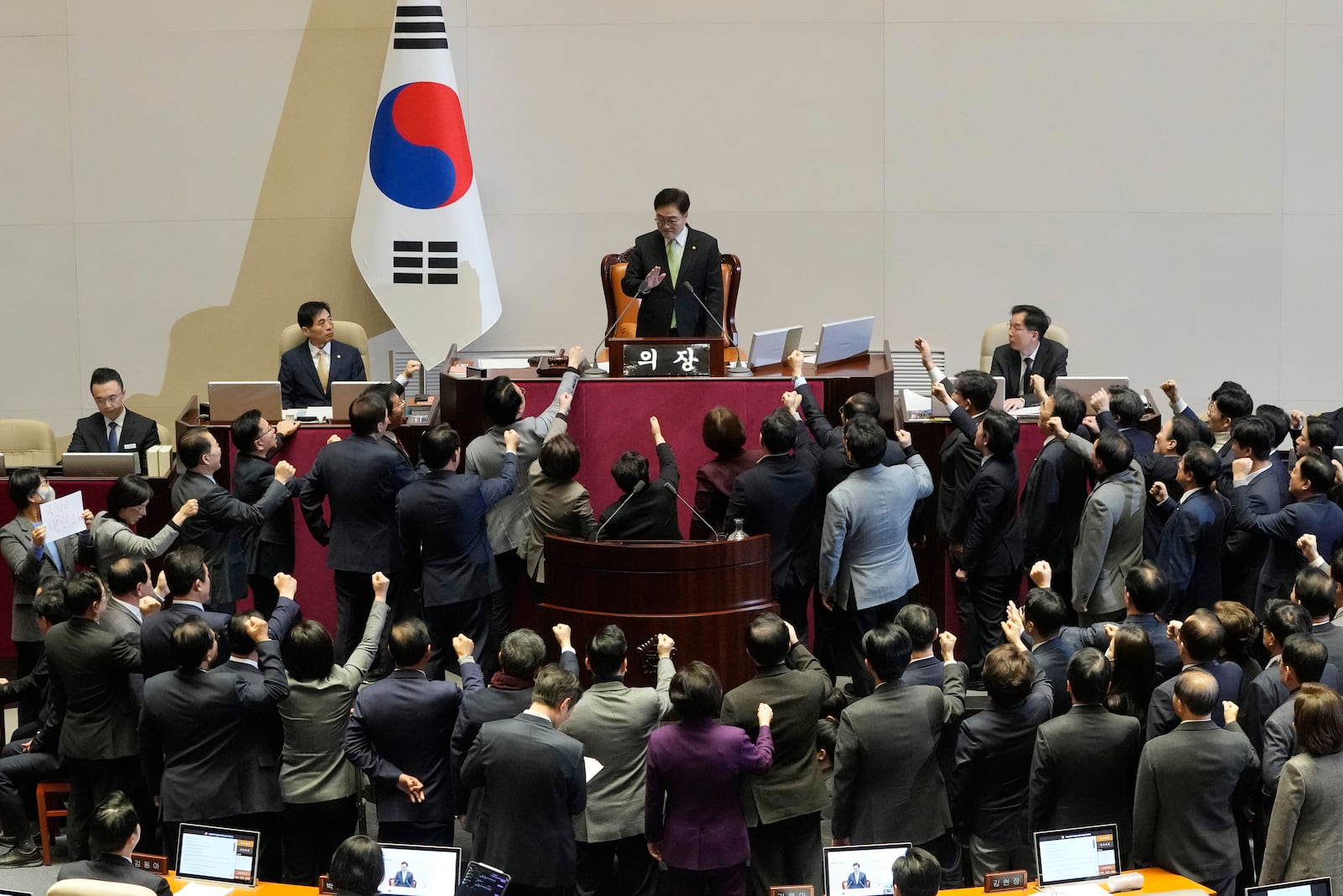 Lawmakers of the ruling People Power Party protest to South Korea's National Assembly Speaker Woo Won Shik, top center, during a plenary session for the impeachment motion against South Korean acting President Han Duck-soo at the National Assembly in Seoul, South Korea, Friday Dec. 27, 2024. (AP Photo/Ahn Young-joon)