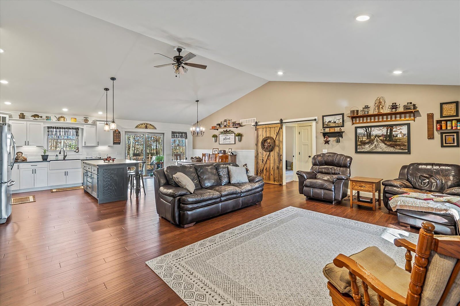 The open concept family room and kitchen has vaulted ceilings, recessed lighting and bamboo laminate flooring.