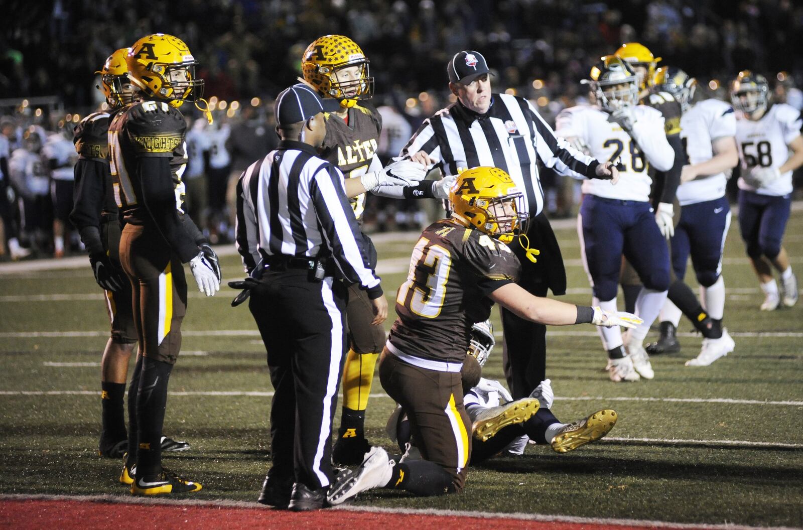 Alter’s Dan O’Connell (43) disputes a catch. Alter defeated Norwalk 34-13 in a D-III high school football state semifinal at Wapakoneta’s Harmon Field on Friday, Nov. 23, 2018. MARC PENDLETON / STAFF