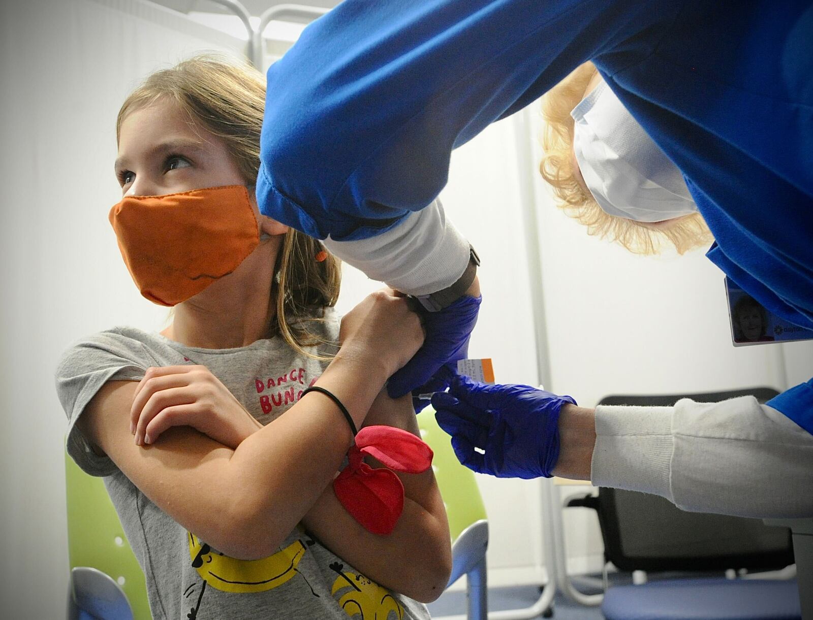 Thea Schicel, age 6, looks at her mother while receiving her COVID-19 vaccine at Dayton Children's Monday, Nov. 8, 2021. MARSHALL GORBY\STAFF