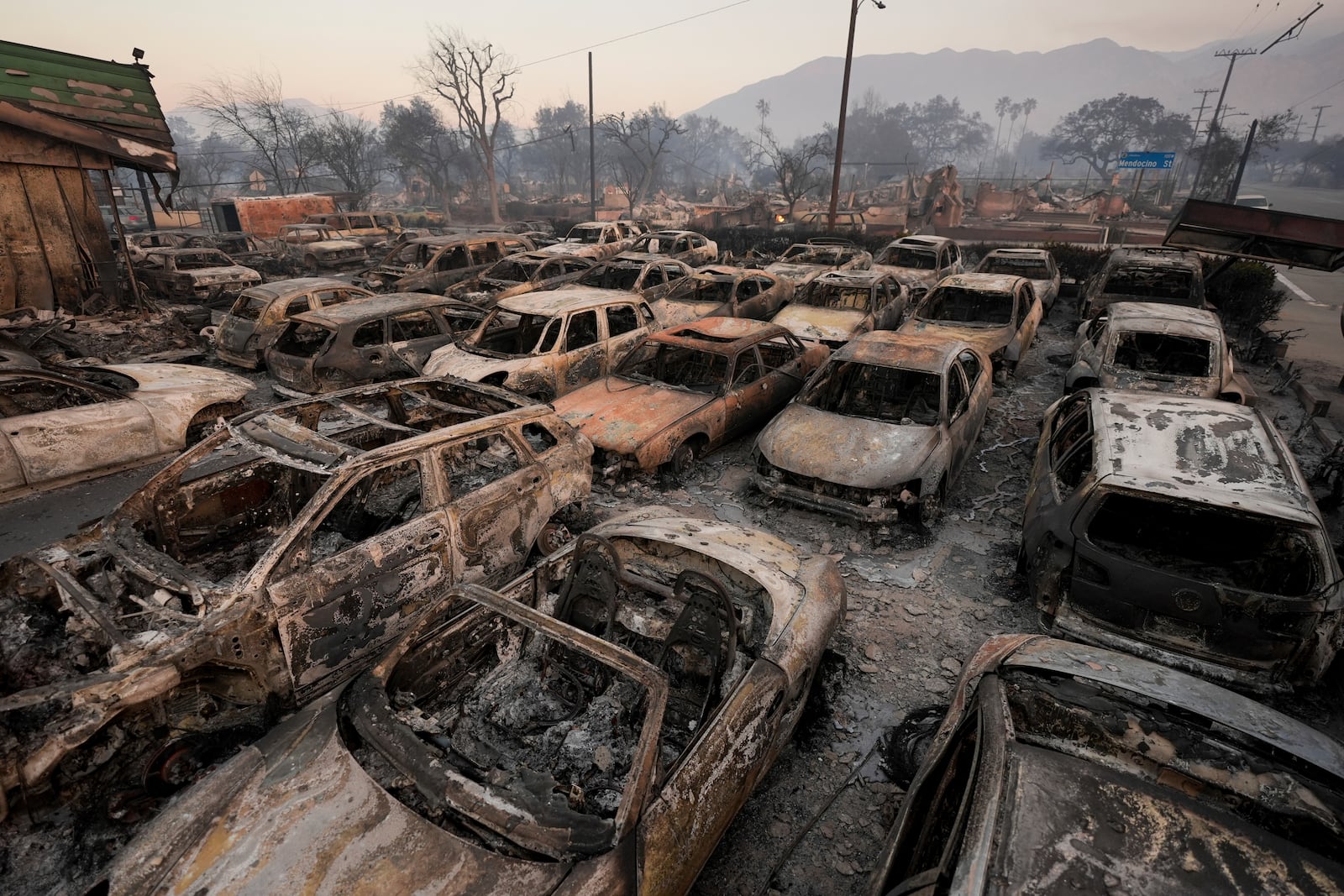 Cars are left charred inside a dealership in the aftermath of the Eaton Fire Friday, Jan. 10, 2025 in Altadena, Calif. (AP Photo/Jae C. Hong)