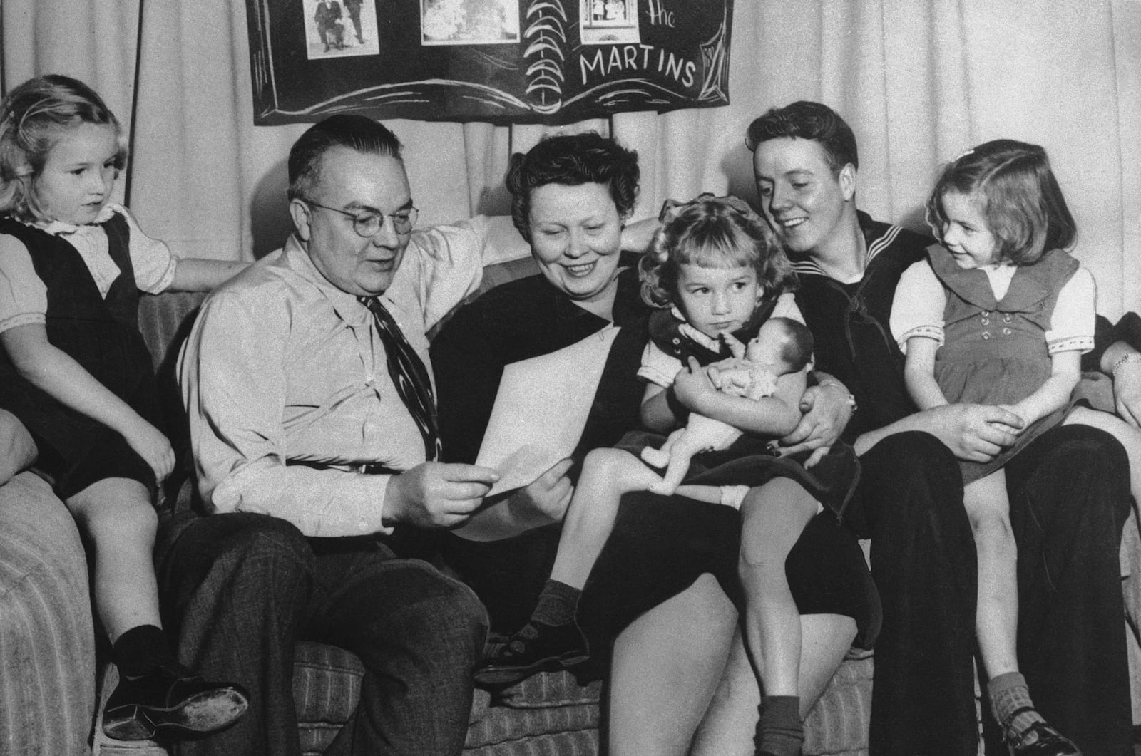 FILE - The 1992 Christmas photo of the Ken Martin family, from left, Barbara, 7; Ken, Barbara, Sue, 4; Donald, 21; and Virginia, 6; in Portland, Ore., in December 1952. (Ken Martin family via AP, File)