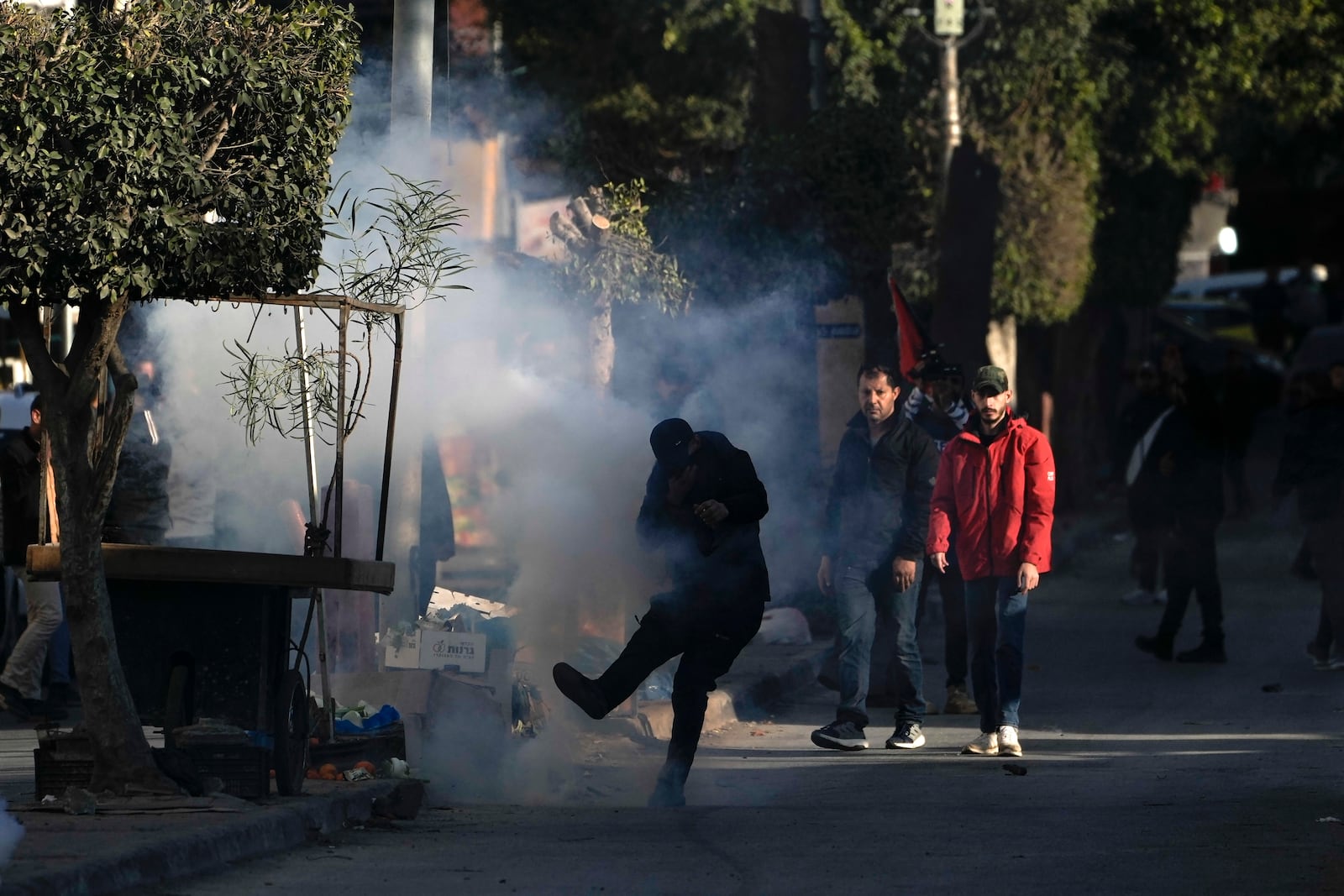 Palestinian youths clash with Palestinian security forces outside the Jenin refugee camp in the Israeli-occupied West Bank, Monday, Dec. 16, 2024. (AP Photo/Majdi Mohammed)