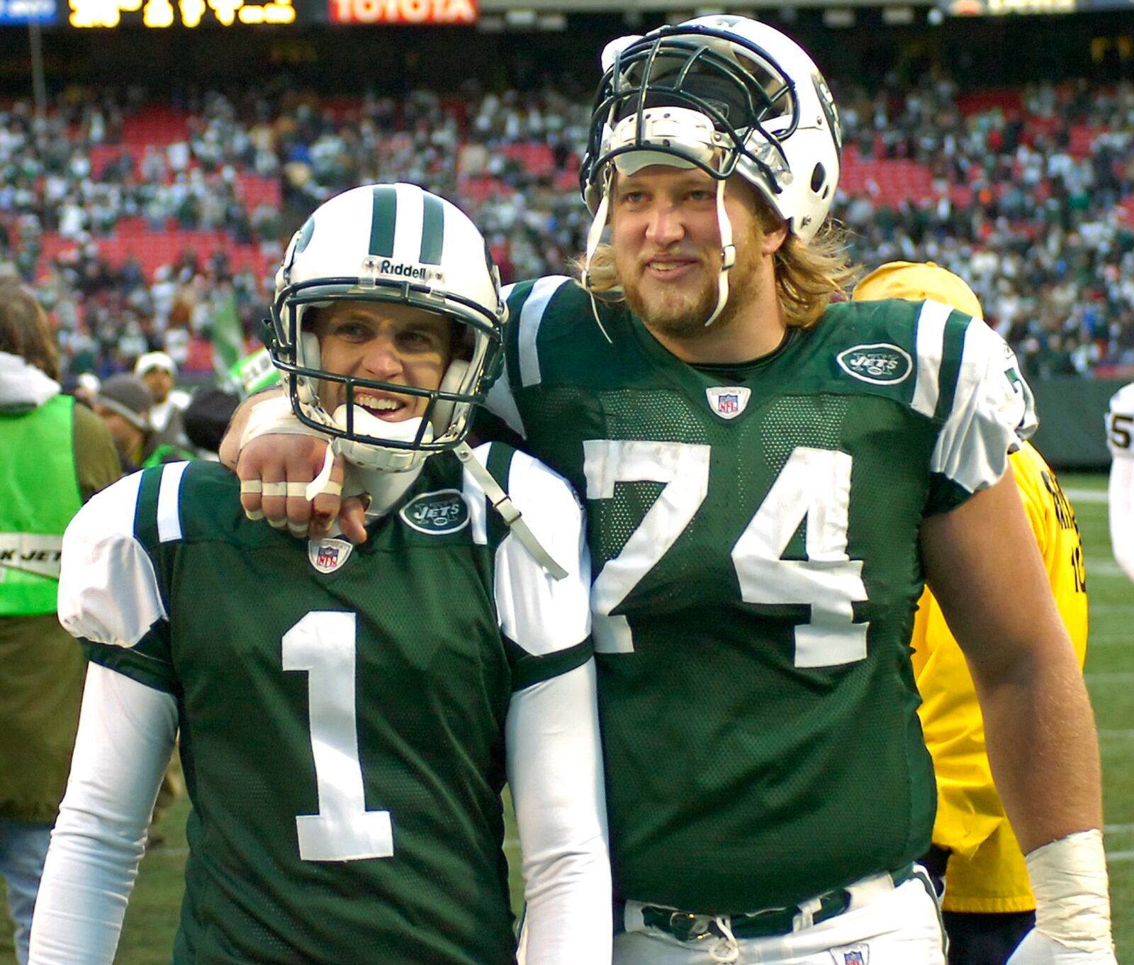 New York Jets center Nick Mangold (74, Alter) and kicker Mike Nugent (Centerville) leave the field after beating the Oakland Raiders, 23-3, to make the playoffs during NFL football Sunday, Dec. 31, 2006 at Giants Stadium in East Rutherford, N.J. (AP Photo/Bill Kostroun)