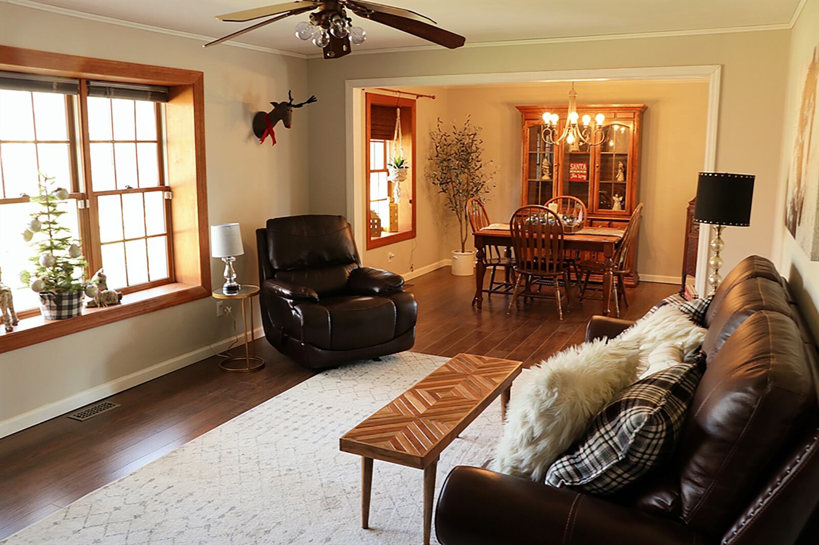 The foyer hallway ends within the formal living room where wood-plank flooring fills the room and continues into the adjoining formal dining room. Both the living room and dining room have updated box windows that provide views of the tree-lined back yard. CONTRIBUTED PHOTO BY KATHY TYLER