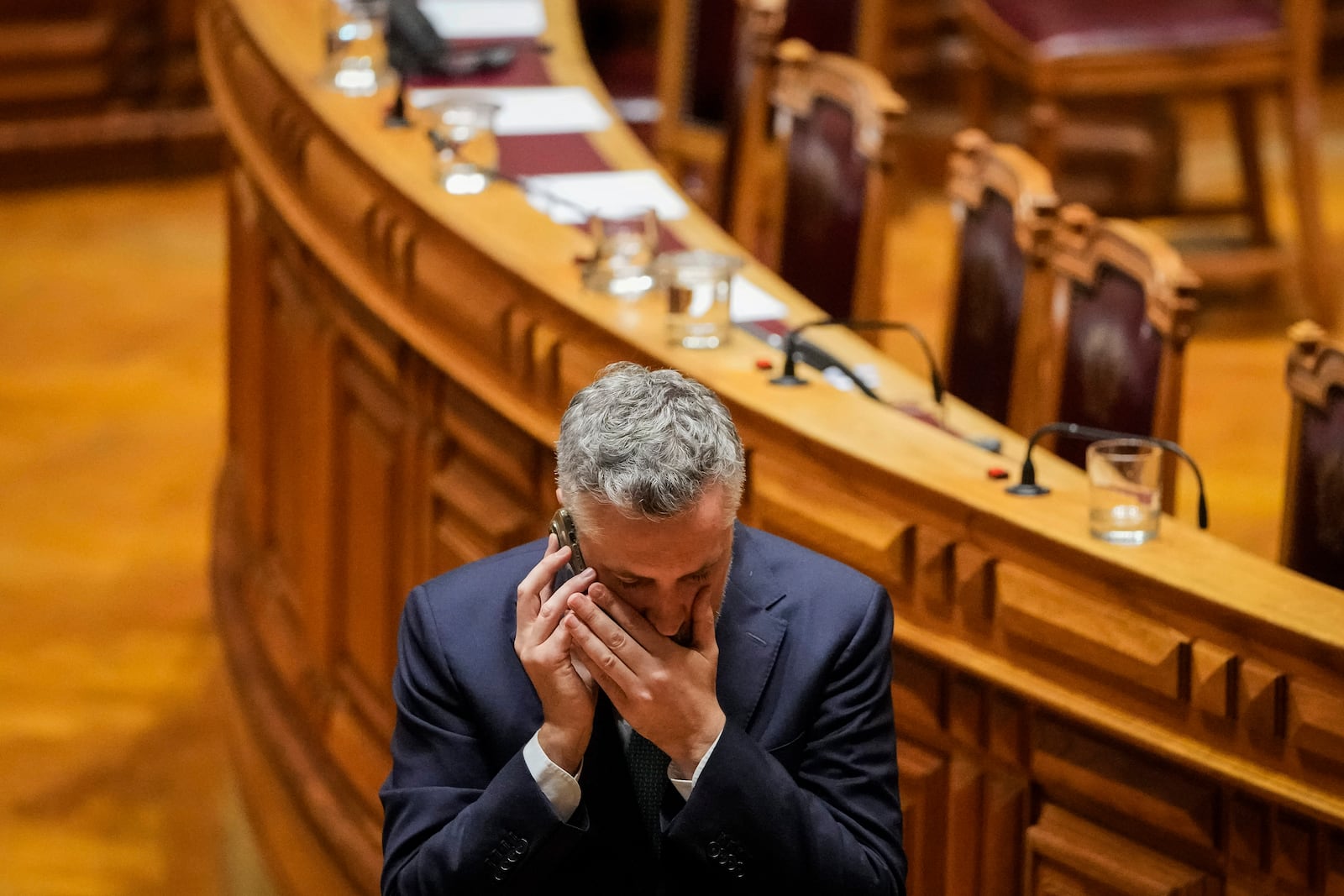 Portuguese Socialist party secretary general Pedro Nuno Santos speaks on the phone during a break in a debate preceding a vote of confidence concerning Portuguese Prime Minister Luis Montenegro at the Portuguese parliament in Lisbon, Tuesday, March 11, 2025. (AP Photo/Armando Franca)