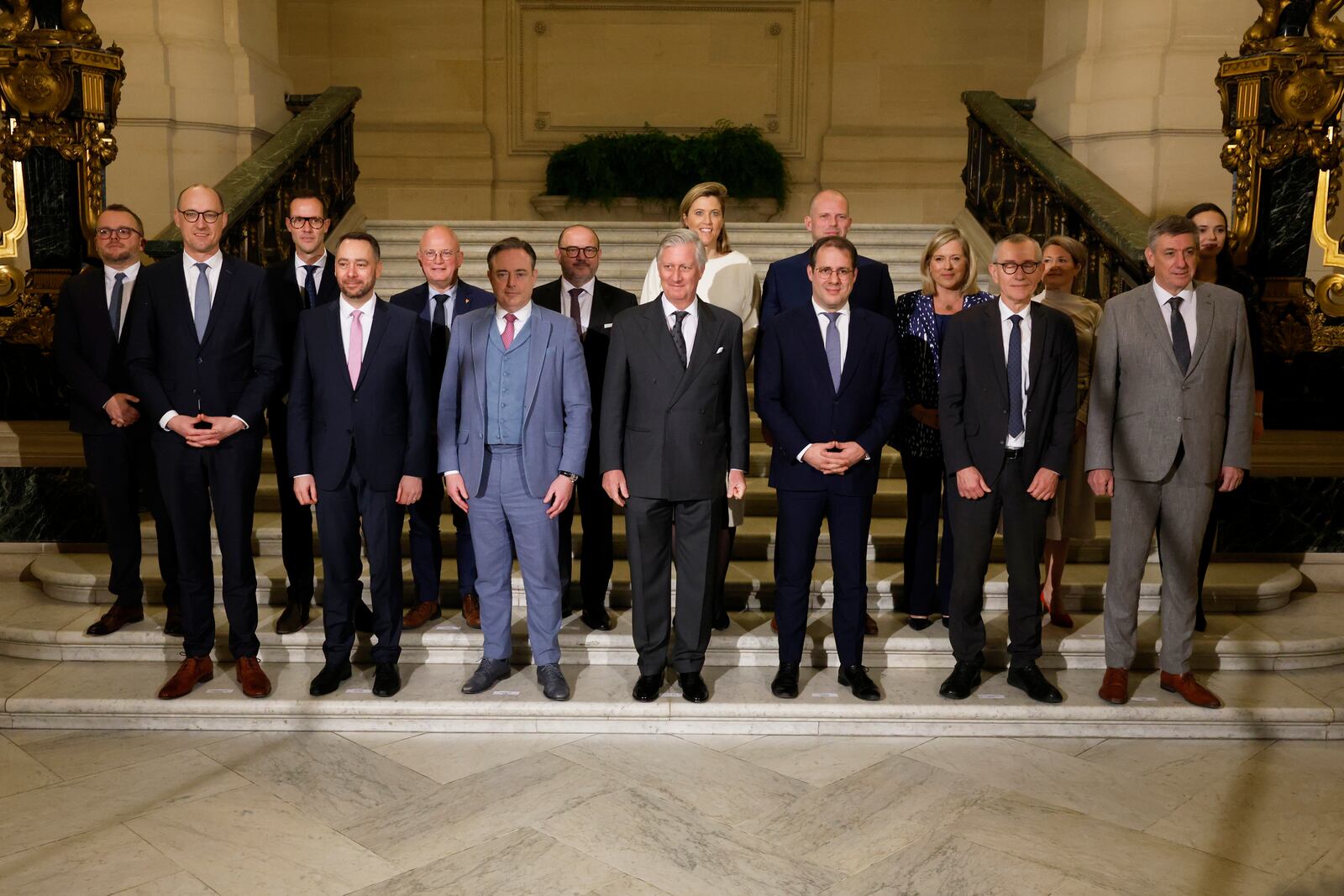 Belgium's King Philippe, center front, and new Belgian Prime Minister Bart De Wever, front center left, pose with ministers after a swearing in ceremony for the new government at the Royal Palace in Brussels, Monday, Feb. 3, 2025. (AP Photo/Omar Havana)