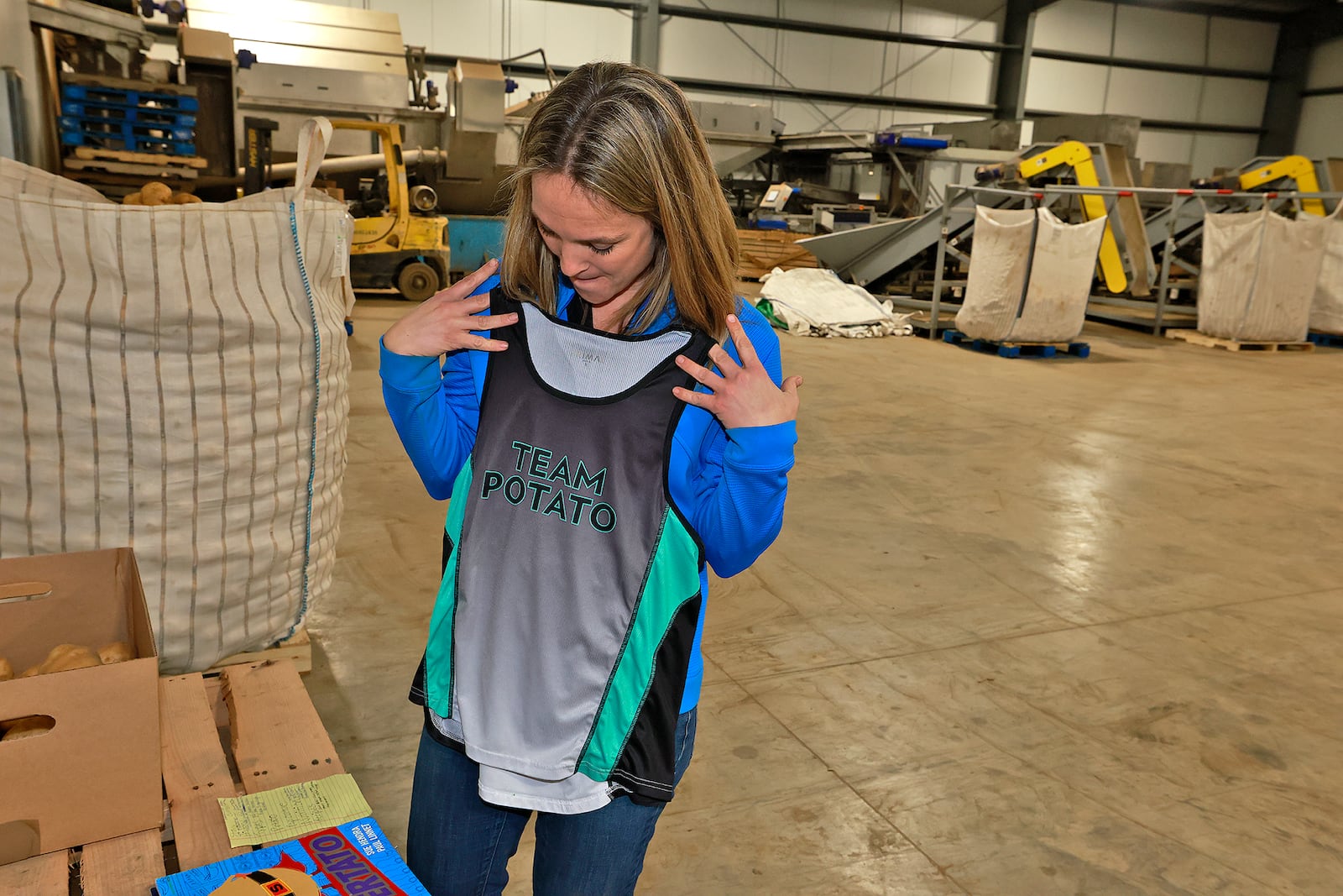 Fourth generation potato farmer, Kathy Sponheim, shows her Team Potato bicycle jersey. Kathy's family supplies potatoes to the great lakes region of the country. BILL LACKEY/STAFF