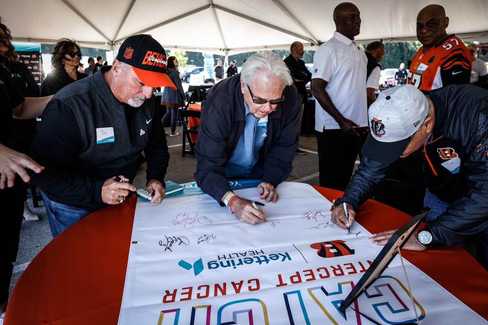 Bengals legends from left, Jim Breech, Scott Perry and Jim Anderson sign banners at the Kettering Health Cancer Center Thursday September 29, 2022. The Bengal legends were at the hospital to deliver care packages, sign banners and visit cancer patients. JIM NOELKER/STAFF