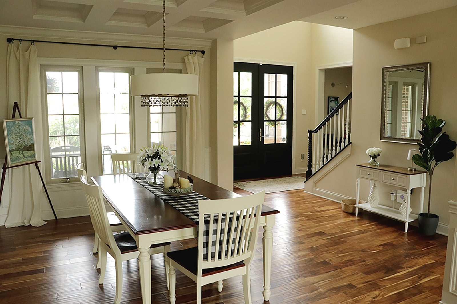 A coffered ceiling is above the formal dining area, which also has wainscoting. Along one wall of the great room is a gas fireplace flanked by built-in cabinetry with bubble-glass panel doors. Shuttered windows with transoms fill another wall. CONTRIBUTED PHOTO BY KATHY TYLER