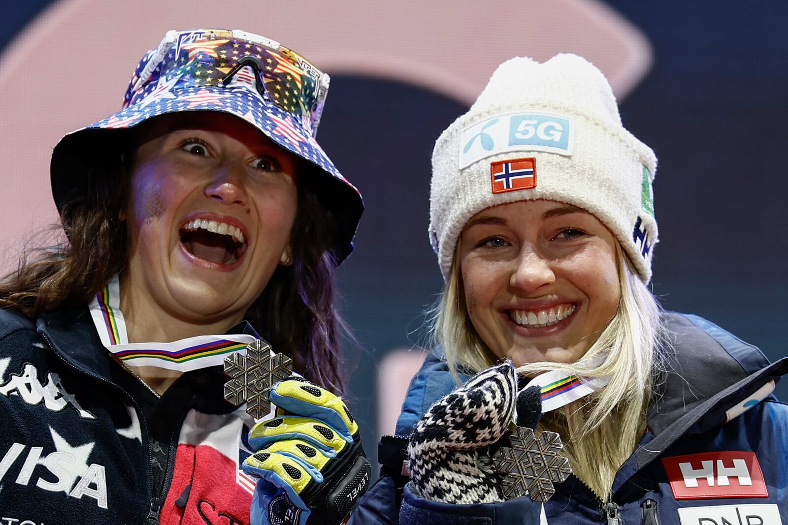 United States' Lauren Macuga, left, and Norway's Kajsa Vickhoff Lie show their joint bronze medal in a women's Super-G, at the Alpine Ski World Championships, in Saalbach-Hinterglemm, Austria, Thursday, Feb. 6, 2025. (AP Photo/Gabriele Facciotti)