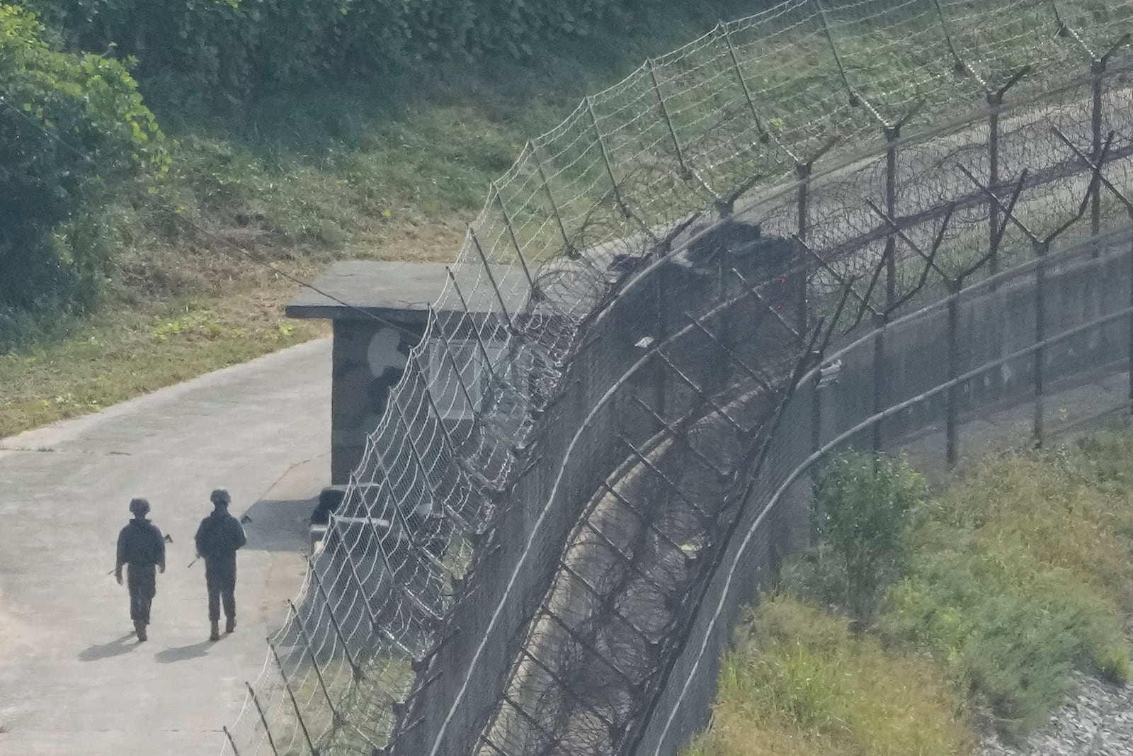 South Korean army soldiers patrol along the barbed-wire fence in Paju, South Korea, near the border with North Korea, Thursday, Oct. 10, 2024. (AP Photo/Ahn Young-joon)