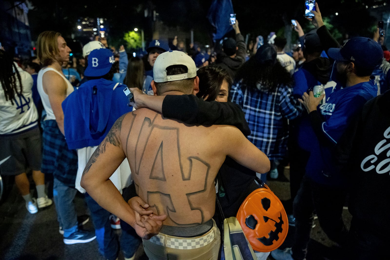 Fans dance while celebrating on the streets after the Los Angeles Dodgers defeated the New York Yankees to win the baseball World Series Wednesday, Oct. 30, 2024, in Los Angeles. (AP Photo/Ethan Swope)