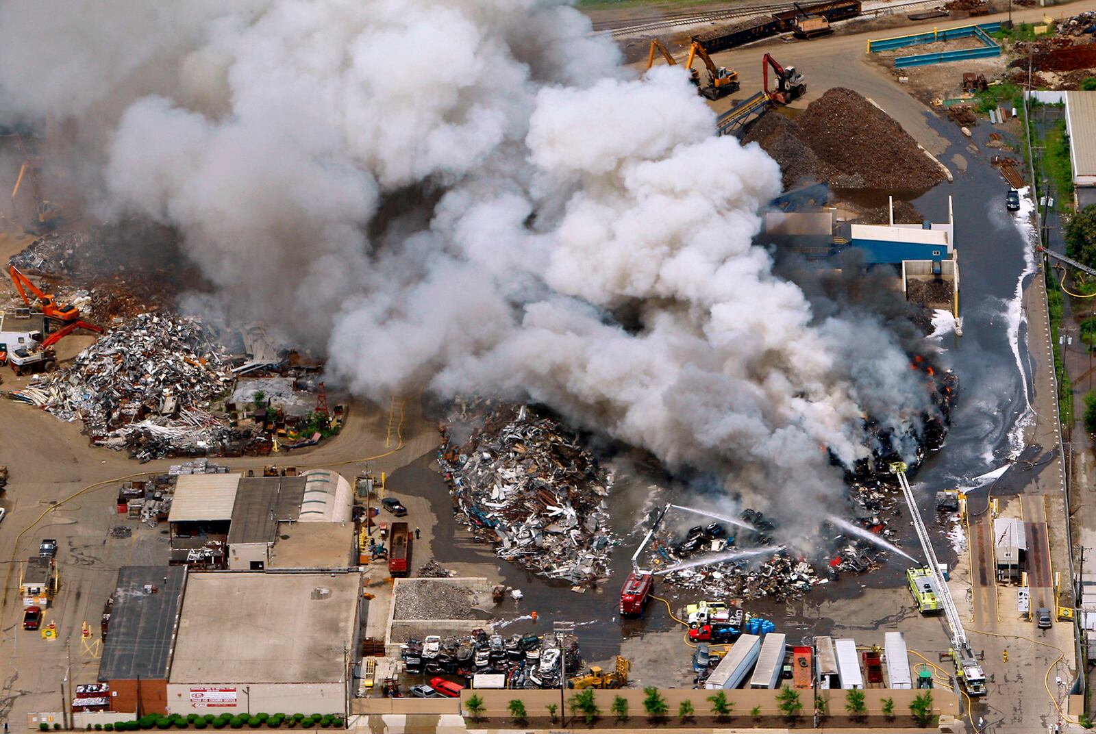 A fire at Franklin Iron and Metal site at 2015 E. First St. continues to burn on the afternoon of Thursday, May 20, and is expected to continue burning for hours. Everyone within two miles of the area is being asked to stay inside because of concerns over possibly toxic smoke billowing from a fire at the scrap yard. The plume of smoke can be seen for miles.