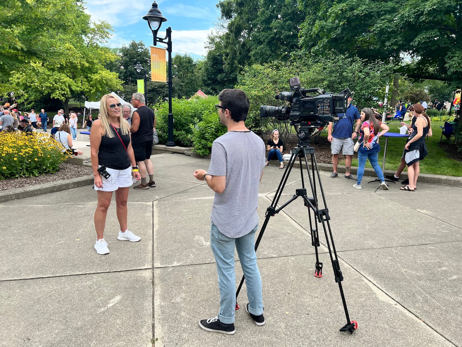 Amy Zahora, executive director of the Miami Valley Restaurant Association, speaking to a news crew at Bacon Fest 2022 at Kettering's Fraze Pavilion. 