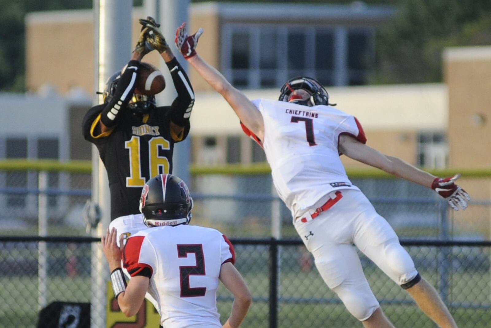 Sidney’s Lathan Jones (16) beats Bellefontaine’s Jack Clement (7) and Ethan Moore for a touchdown catch. Sidney defeated visiting Bellefontaine 31-28 in a Week 2 high school football game on Thursday, Aug. 30, 2018. MARC PENDLETON / STAFF