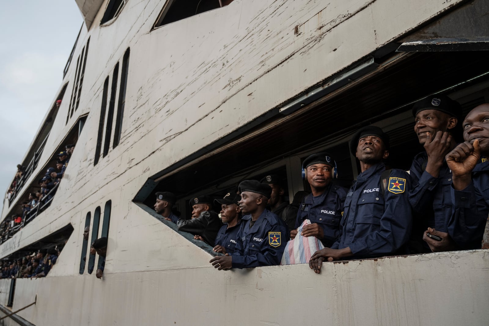 Former members of the Armed Forces of the Democratic Republic of Congo (FARDC) and police officers who allegedly surrendered to M23 rebels arrive in Goma, Congo, Sunday, Feb. 23, 2025. (AP Photo/Moses Sawasawa)