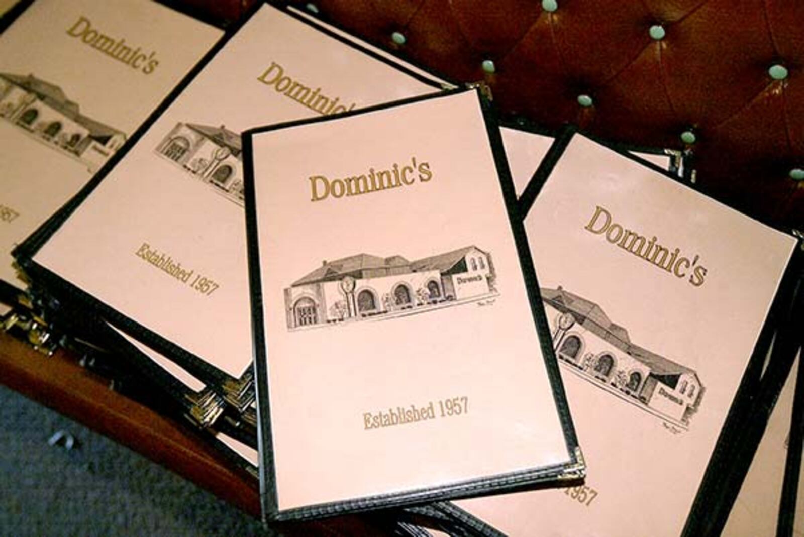 Dozens of menus were stacked up to be sold during an auction at Dominic's, the landmark restaurant at 1066 S. Main St. in Dayton.