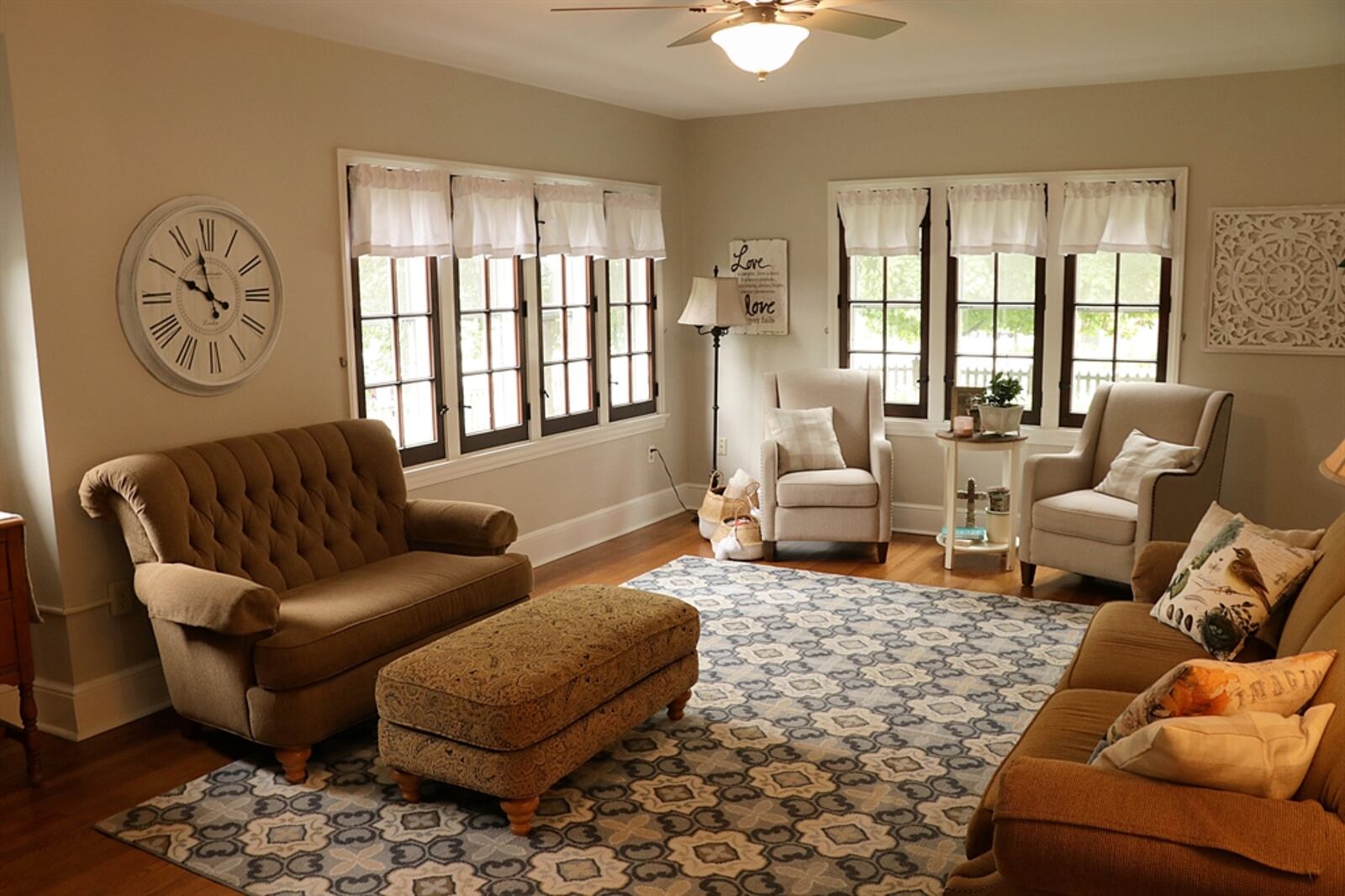 Both the living and the dining rooms have glass-panel doors that open into an enclosed porch or sun room. The room has two walls of windows and exposed brick walls that match the terra-cotta tile flooring. Kathy Tyler/CONTRIBUTED