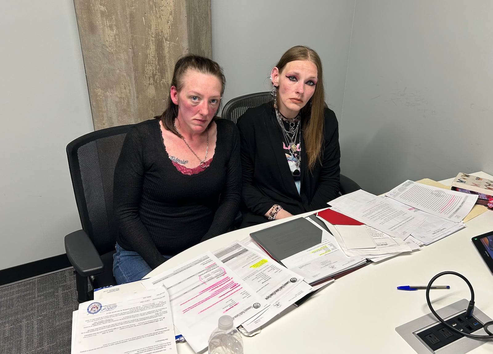 April Alvarenga (left) and her close friend Heather Gruber show the stacks of legal paperwork related to their effort to prevent the deportation of April's husband, Jose Antonio Alvarenga. JEREMY P. KELLEY / STAFF