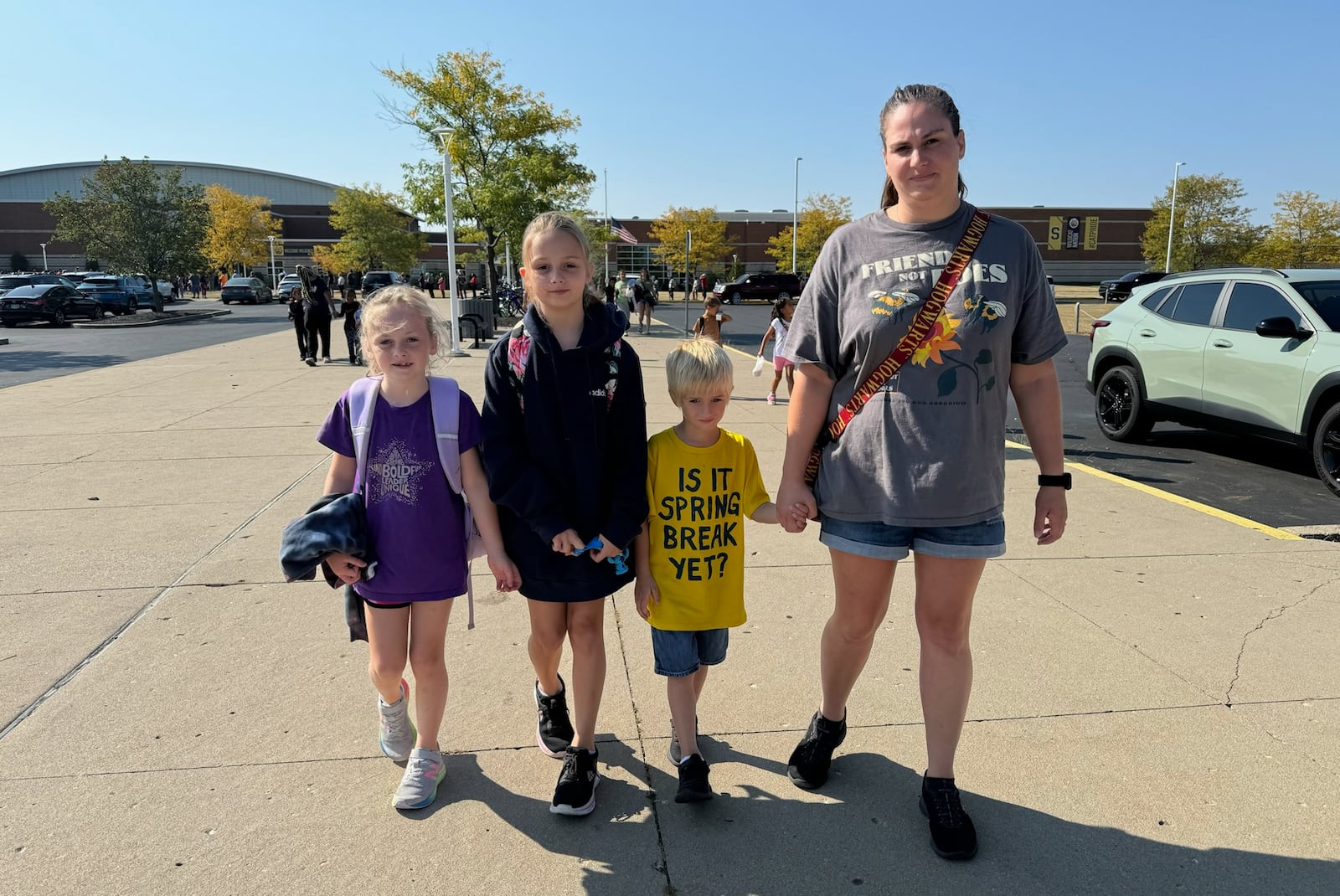 Kristin Karkan picks up her three children at Springfield High School Monday, Sept. 16, 2024 after they were evacuated from Kenwood School. BILL LACKEY/STAFF