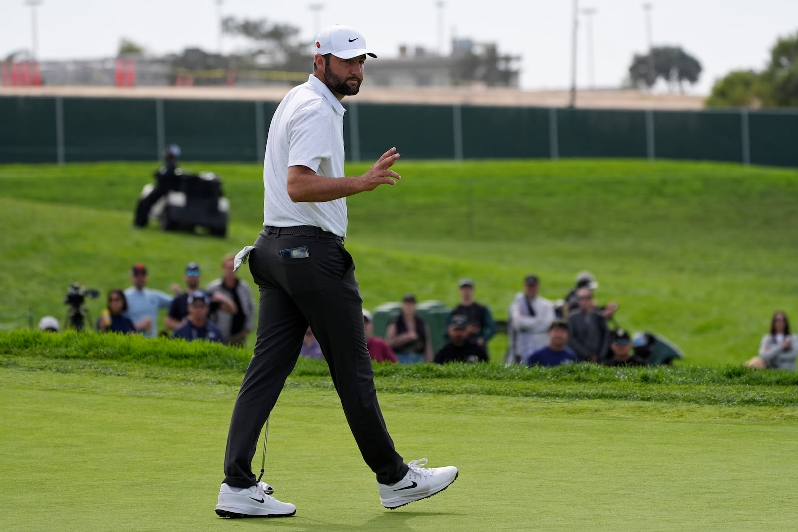 Scottie Scheffler reacts after making a birdie on the 13th hole of the South Course at Torrey Pines during the final round of the Genesis Invitational golf tournament Sunday, Feb. 16, 2025, in San Diego. (AP Photo/Gregory Bull)